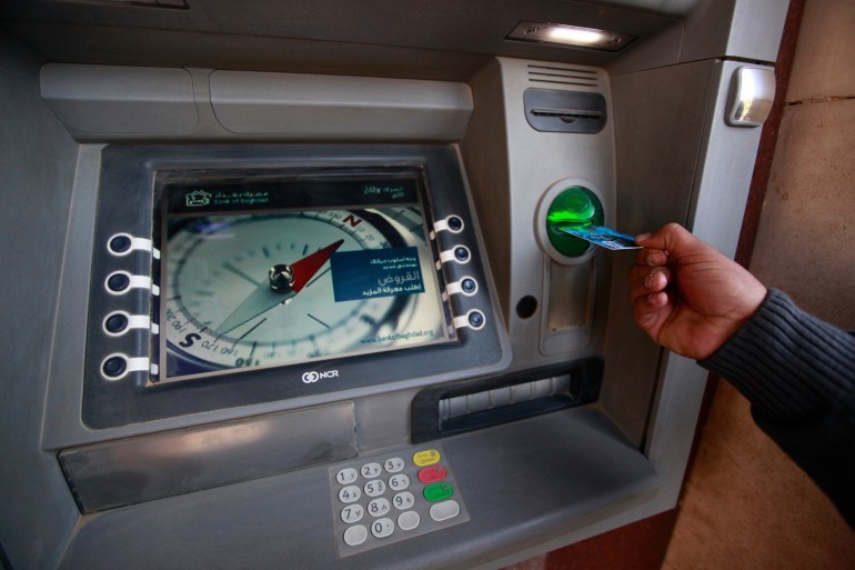 A man uses an ATM machine at a bank in Baghdad March 4, 2012. The lack of efficient banking is holding the country back as it rebuilds its economy after the underinvestment of the Saddam Hussein years and the turmoil that followed the 2003 U.S.-led invasion. Without banks that are integrated into the global financial system, foreign investors outside the oil sector are likely to continue hesitating to commit large sums to Iraq. Picture taken March 4, 2012. To match Feature IRAQ-BANKING / REUTERS/Mohammed Ameen (IRAQ - Tags: BUSINESS)