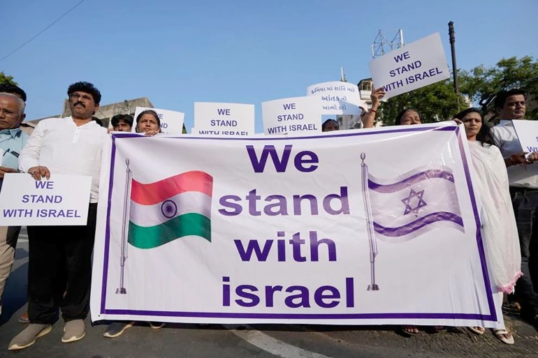 People hold placards and a banner in solidarity with Israel in Ahmedabad, India, Oct. 16, 2023. Credit: AP Photo/Ajit Solanki